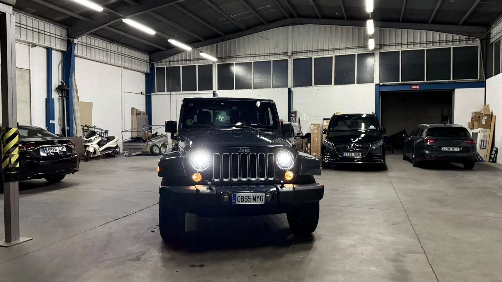 Jeep Wrangler Sahara front with lights on